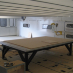 Internal view of machine roof covering an automated machining table work area