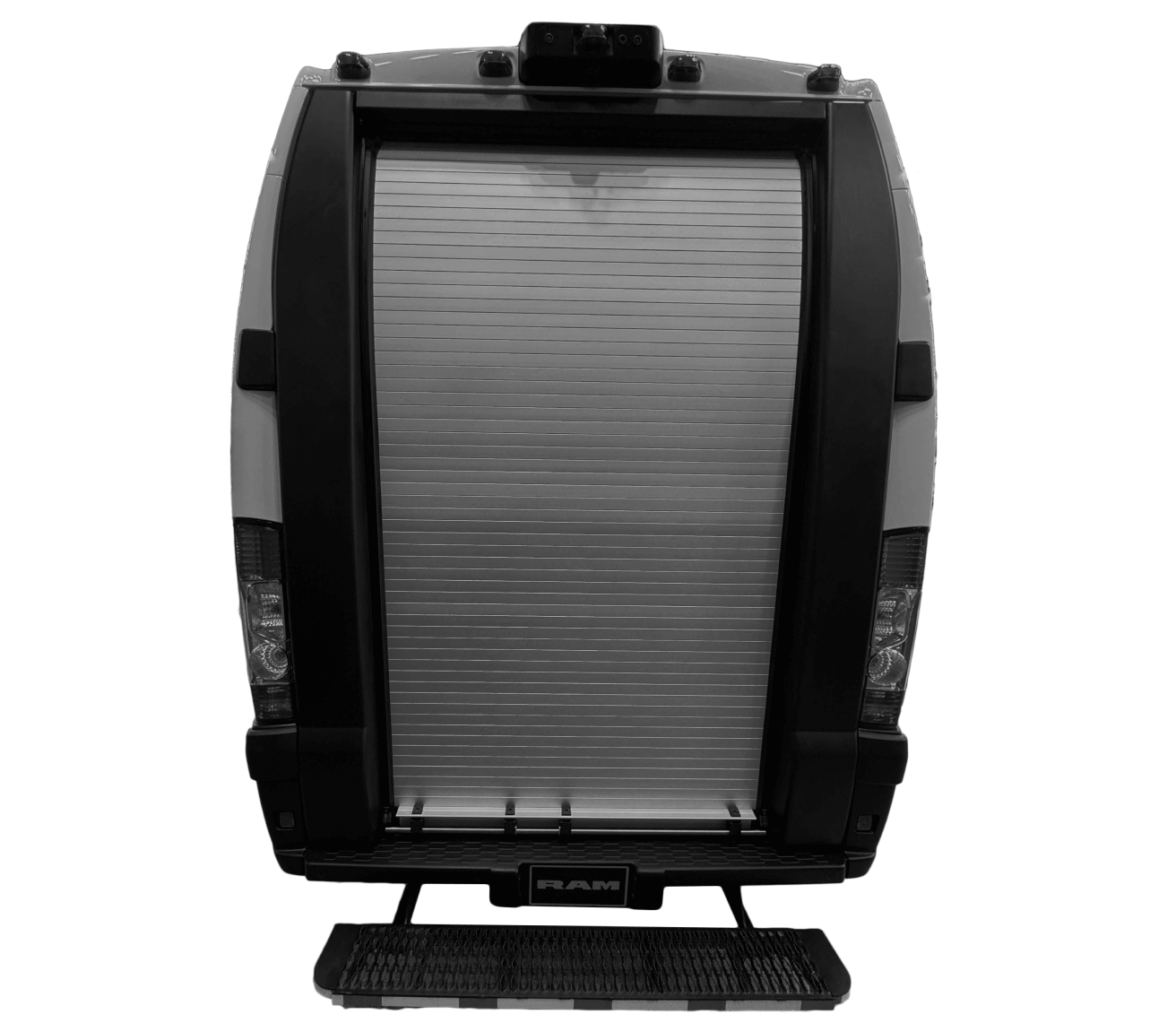 The image shows the rear view of a vehicle with a metallic roll-up door. The door is closed, and there are taillights on both sides. The word RAM is visible at the bottom on the step. The image is in black and white.