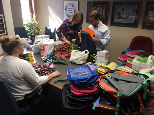 Employees working on school supply drive community support project